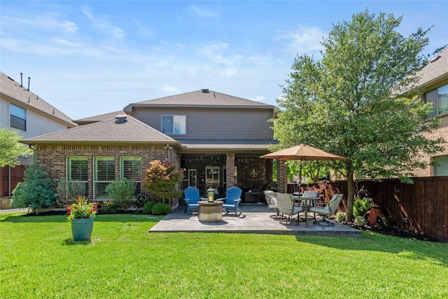 1704 Landon Ln, Mckinney, TX 75071 - back of property with a patio area, brick siding, and roof with shingles