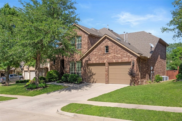 1704 Landon Ln, Mckinney, TX 75071 - view of front of home with brick siding, concrete driveway, a garage, and a front lawn