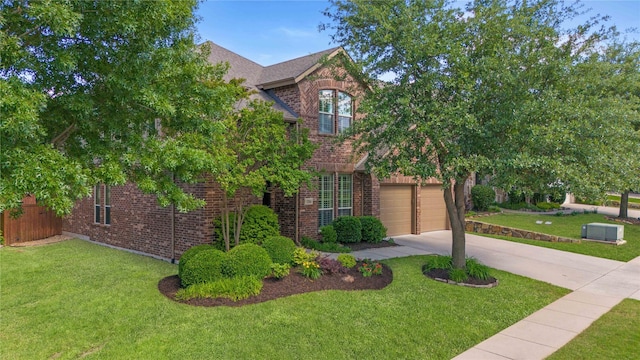1704 Landon Ln, Mckinney, TX 75071 - traditional home with brick siding, concrete driveway, a front yard, and a garage