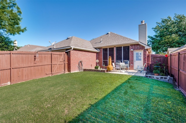 1699 Garrison Dr, Frisco, TX 75033 - back of house with brick siding, a chimney, roof with shingles, a patio area, and a sunroom