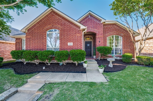 1699 Garrison Dr, Frisco, TX 75033 - traditional home featuring brick siding and a front lawn