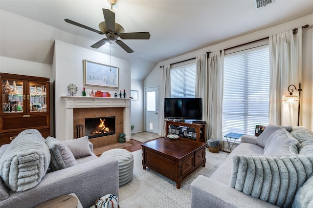 1699 Garrison Dr, Frisco, TX 75033 - living area featuring vaulted ceiling, a tiled fireplace, and ceiling fan