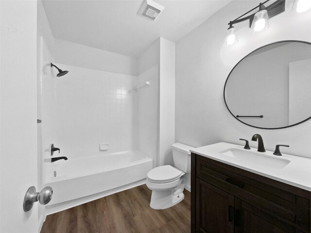 5205 Foley Dr, Arlington, TX 76013 - bathroom with wood finished floors, toilet, vanity, and shower / bath combination