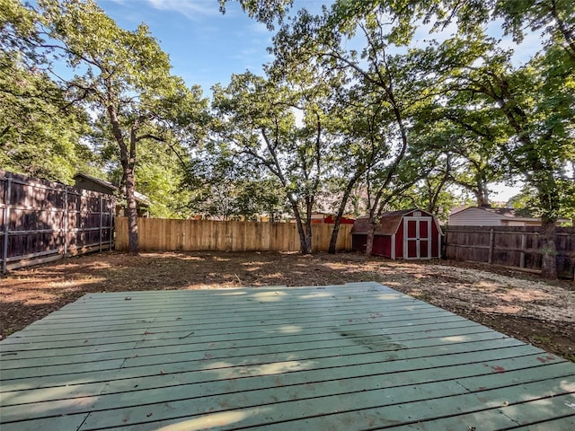 5205 Foley Dr, Arlington, TX 76013 - deck with a storage unit, a fenced backyard, and an outdoor structure