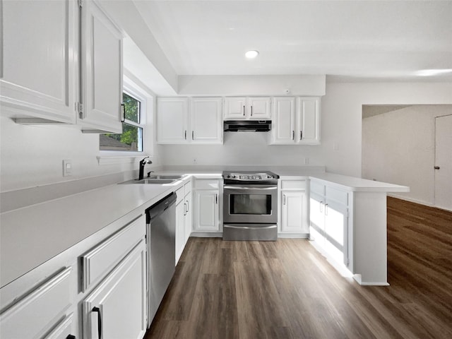 5205 Foley Dr, Arlington, TX 76013 - kitchen featuring appliances with stainless steel finishes, a sink, under cabinet range hood, a peninsula, and light countertops