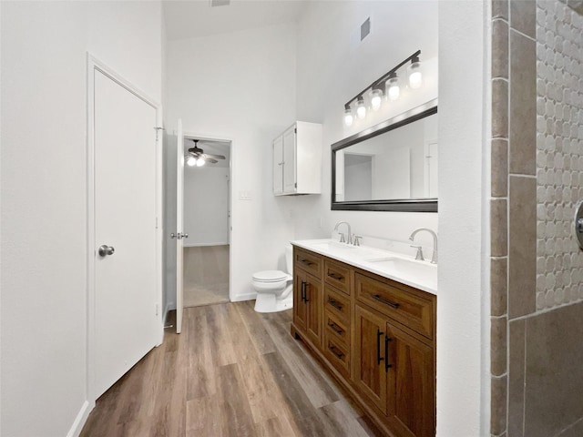 5205 Foley Dr, Arlington, TX 76013 - full bath featuring wood finished floors, a ceiling fan, double vanity, a high ceiling, and toilet