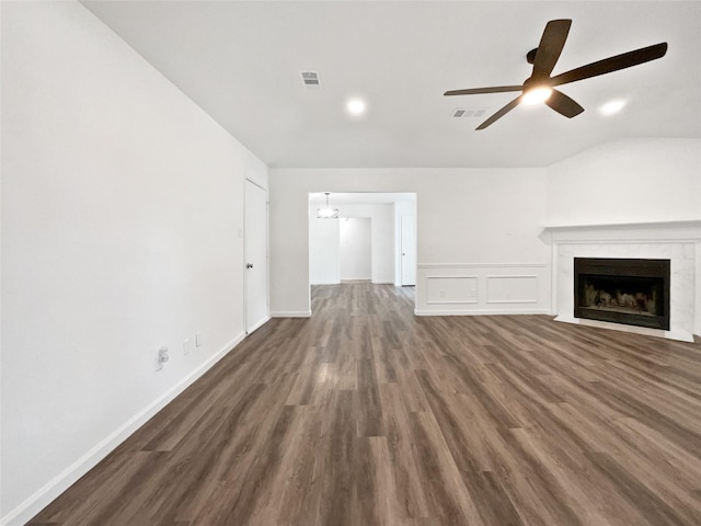 5205 Foley Dr, Arlington, TX 76013 - unfurnished living room featuring ceiling fan, vaulted ceiling, a premium fireplace, dark wood-style flooring, and a chandelier
