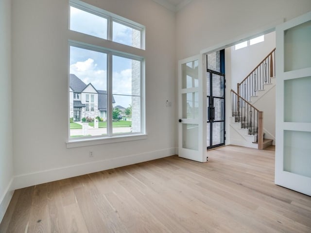 1045 Bent Tree Ln, Gunter, TX 75058 - entrance foyer featuring french doors, plenty of natural light, baseboards, and light wood-style flooring