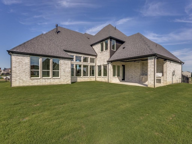 1045 Bent Tree Ln, Gunter, TX 75058 - back of property with a shingled roof, brick siding, a patio, and a yard