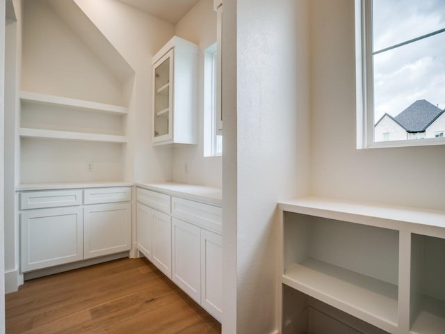 1045 Bent Tree Ln, Gunter, TX 75058 - kitchen featuring open shelves, white cabinets, light wood-style floors, and built in shelves
