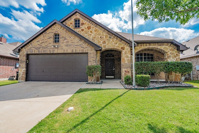 127 Wandering Dr, Forney, TX 75126 - view of front of home with brick siding, a front yard, and driveway
