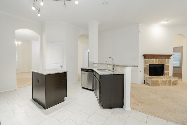 127 Wandering Dr, Forney, TX 75126 - kitchen with an island with sink, stainless steel dishwasher, a sink, arched walkways, and crown molding