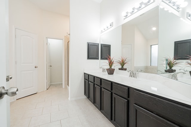 127 Wandering Dr, Forney, TX 75126 - full bathroom with double vanity, tile patterned flooring, baseboards, a shower, and high vaulted ceiling