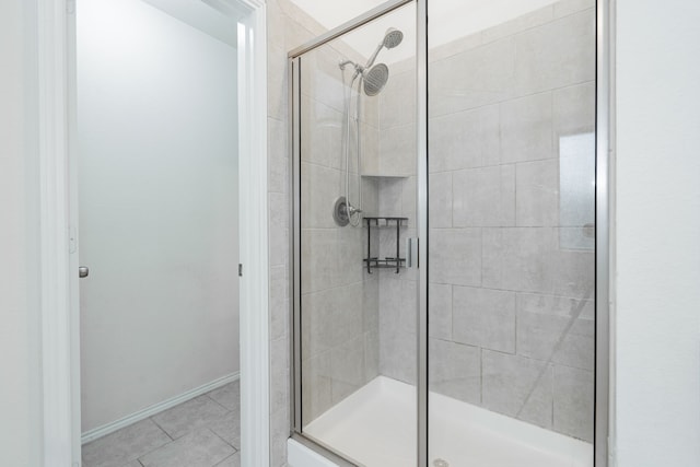 127 Wandering Dr, Forney, TX 75126 - bathroom with a stall shower, tile patterned flooring, and baseboards