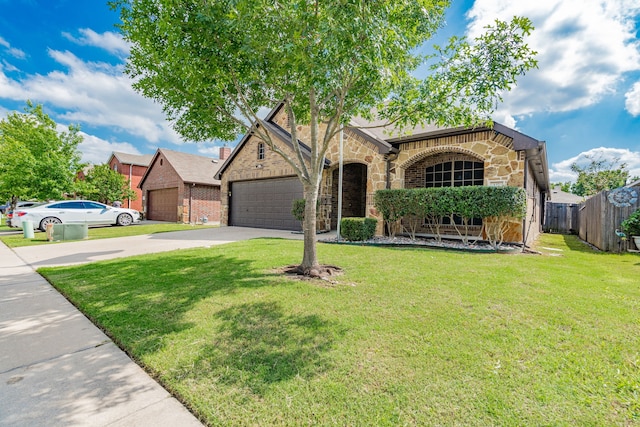 127 Wandering Dr, Forney, TX 75126 - view of front of house featuring stone siding, driveway, and an attached garage