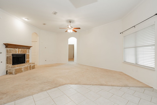 127 Wandering Dr, Forney, TX 75126 - unfurnished living room with light carpet, arched walkways, a ceiling fan, crown molding, and a fireplace