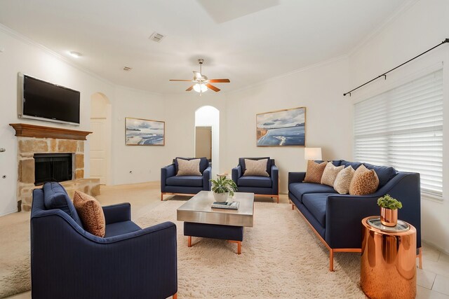 127 Wandering Dr, Forney, TX 75126 - living area with arched walkways, crown molding, ceiling fan, a stone fireplace, and baseboards
