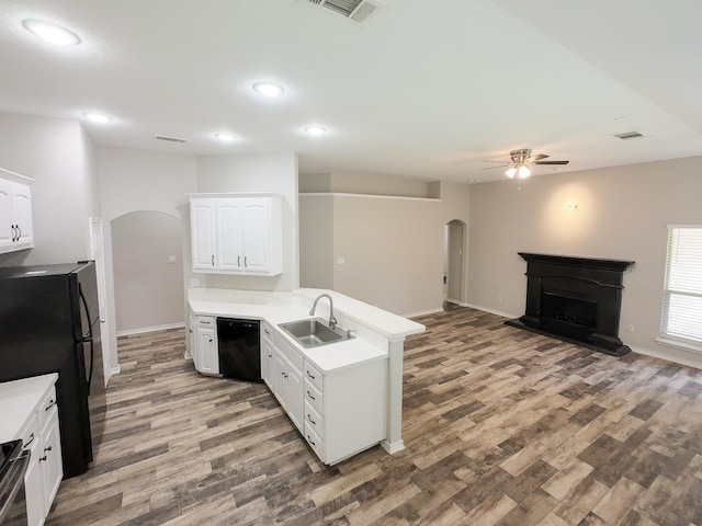 204 Spring Hollow Dr, Saginaw, TX 76131 - kitchen with arched walkways, a sink, ceiling fan, black appliances, and a peninsula