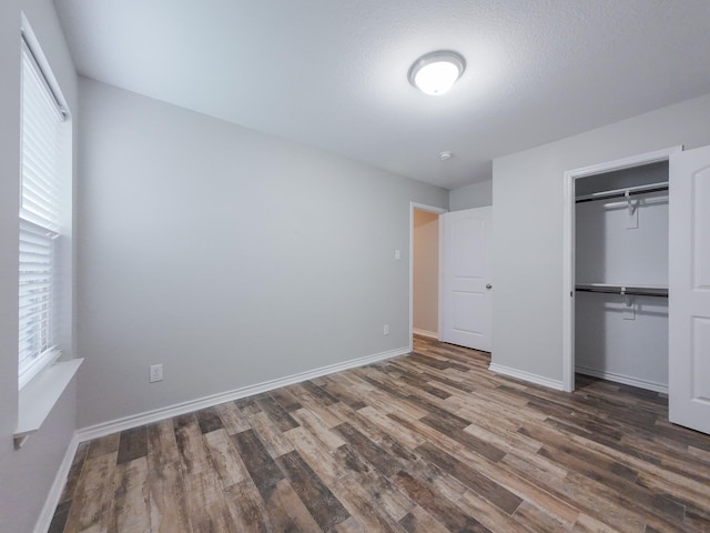 204 Spring Hollow Dr, Saginaw, TX 76131 - unfurnished bedroom with wood finished floors, baseboards, and a closet
