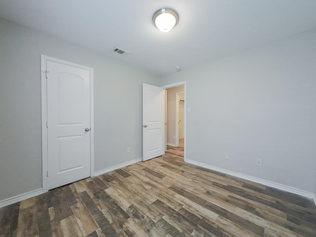 204 Spring Hollow Dr, Saginaw, TX 76131 - unfurnished bedroom with wood finished floors and baseboards