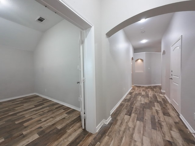 204 Spring Hollow Dr, Saginaw, TX 76131 - hallway with arched walkways, dark wood finished floors, lofted ceiling, and baseboards