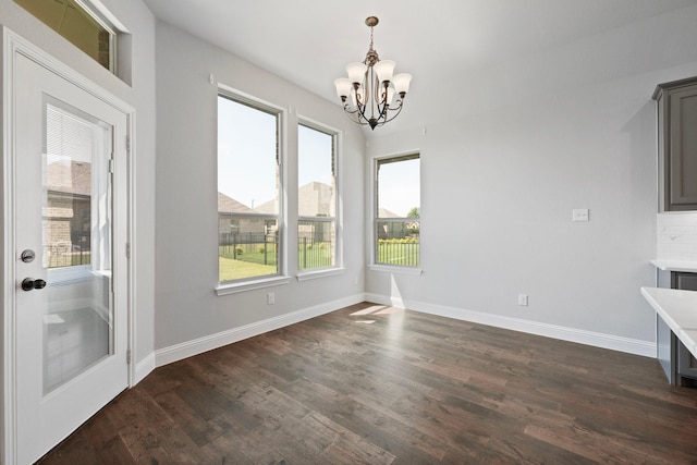 1038 Mickelson Dr, Granbury, TX 76048 - unfurnished dining area featuring a chandelier, dark wood-style floors, and baseboards