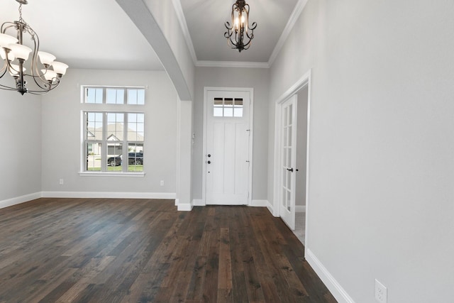 1038 Mickelson Dr, Granbury, TX 76048 - entryway with a chandelier, arched walkways, dark wood-type flooring, baseboards, and crown molding