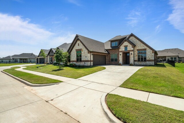 1038 Mickelson Dr, Granbury, TX 76048 - french provincial home with stone siding, concrete driveway, and a garage