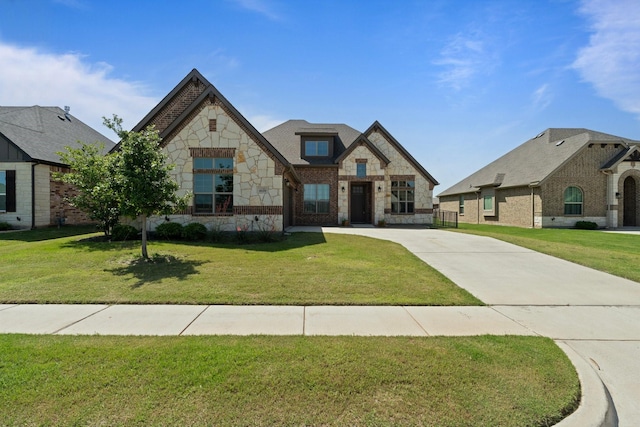 1038 Mickelson Dr, Granbury, TX 76048 - french country style house with stone siding, a front yard, concrete driveway, and brick siding