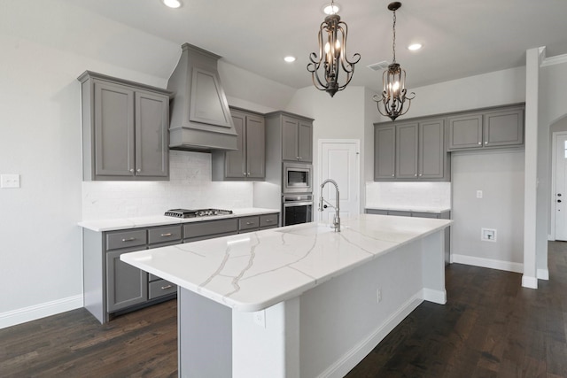 1038 Mickelson Dr, Granbury, TX 76048 - kitchen with gray cabinetry, stainless steel appliances, a chandelier, backsplash, and recessed lighting