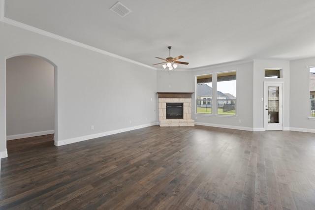 1038 Mickelson Dr, Granbury, TX 76048 - unfurnished living room with ceiling fan, ornamental molding, dark wood-style flooring, baseboards, and a stone fireplace