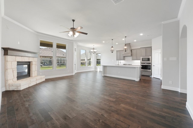 1038 Mickelson Dr, Granbury, TX 76048 - unfurnished living room featuring a ceiling fan, a chandelier, recessed lighting, dark wood finished floors, and baseboards
