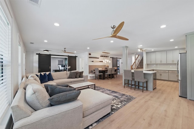 801 Edgefield Rd, Fort Worth, TX 76107 - living area featuring ceiling fan, a barn door, recessed lighting, light wood-style floors, and stairs