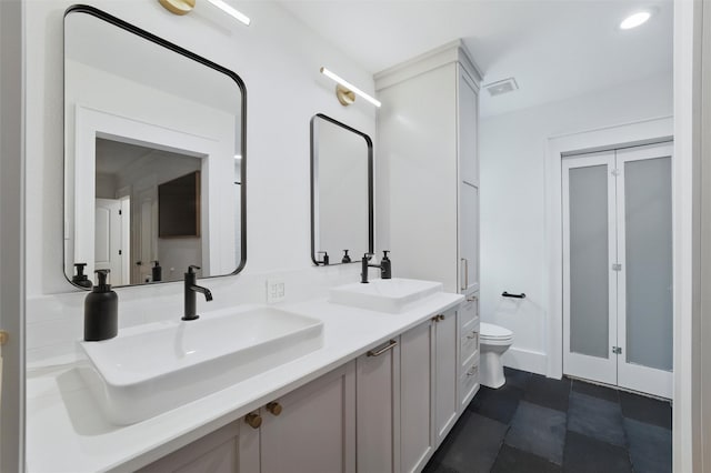 801 Edgefield Rd, Fort Worth, TX 76107 - bathroom featuring toilet and double vanity