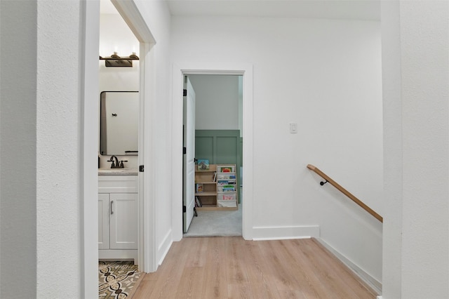 801 Edgefield Rd, Fort Worth, TX 76107 - hallway featuring an upstairs landing, light wood-type flooring, and a sink