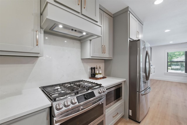 801 Edgefield Rd, Fort Worth, TX 76107 - kitchen with stainless steel appliances, under cabinet range hood, light countertops, recessed lighting, and light wood-style flooring