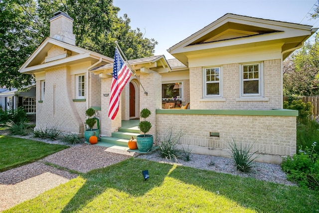 2133 Weatherbee St, Fort Worth, TX 76110 - neoclassical home featuring a chimney, a front yard, and brick siding