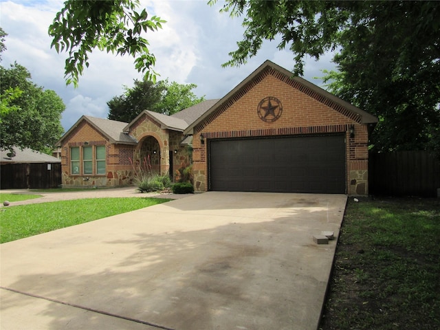 2817 Henry Rd, Lancaster, TX 75134 - view of front of property featuring stone siding, concrete driveway, an attached garage, and brick siding