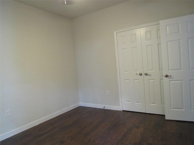 2817 Henry Rd, Lancaster, TX 75134 - unfurnished bedroom featuring baseboards, dark wood-type flooring, and a closet