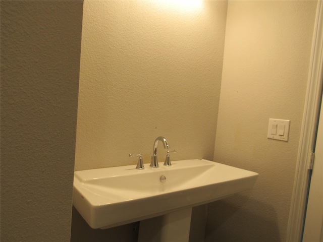 2817 Henry Rd, Lancaster, TX 75134 - bathroom with a textured wall and a sink