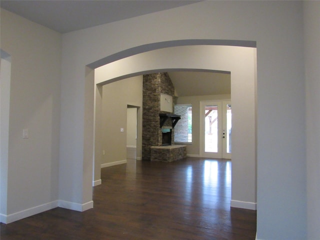 2817 Henry Rd, Lancaster, TX 75134 - unfurnished living room with wood finished floors, baseboards, arched walkways, and french doors
