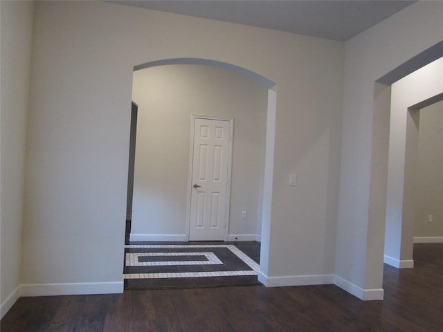 2817 Henry Rd, Lancaster, TX 75134 - unfurnished room featuring arched walkways, wood finished floors, and baseboards