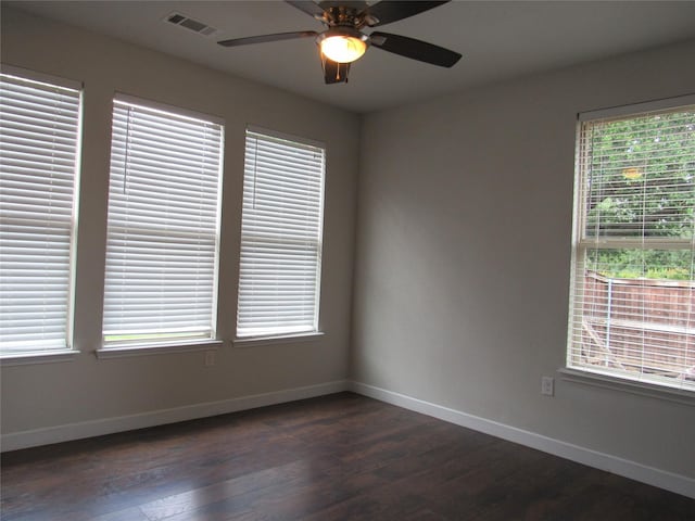 2817 Henry Rd, Lancaster, TX 75134 - unfurnished room featuring dark wood-style flooring, baseboards, and a ceiling fan