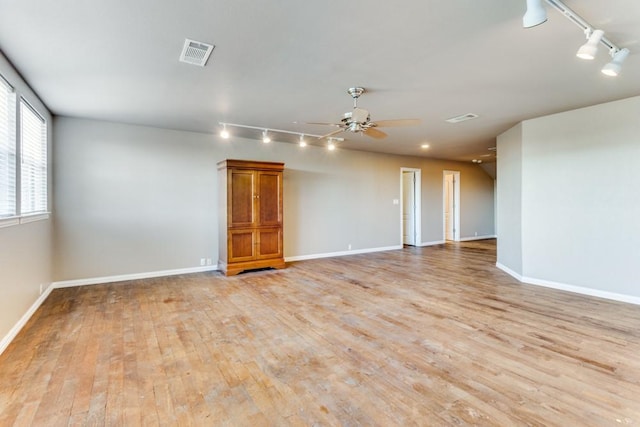 6306 Shadow Valley Dr, Burleson, TX 76028 - empty room with rail lighting, light wood finished floors, ceiling fan, and baseboards