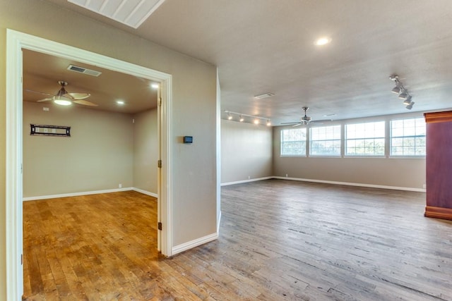 6306 Shadow Valley Dr, Burleson, TX 76028 - empty room featuring a ceiling fan, track lighting, wood finished floors, and baseboards