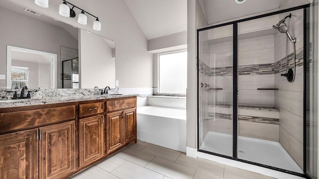 4907 Lakepark Dr, Sanger, TX 76266 - bathroom featuring a shower stall, lofted ceiling, double vanity, a bath, and tile patterned floors