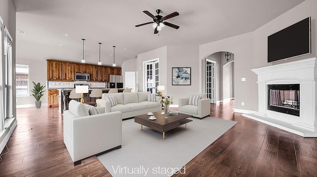 4907 Lakepark Dr, Sanger, TX 76266 - living room with a ceiling fan, arched walkways, dark wood finished floors, baseboards, and recessed lighting