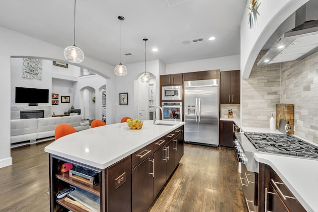 212 Saint Tropez Dr, Southlake, TX 76092 - kitchen featuring built in appliances, wall chimney range hood, light countertops, dark wood-style floors, and recessed lighting