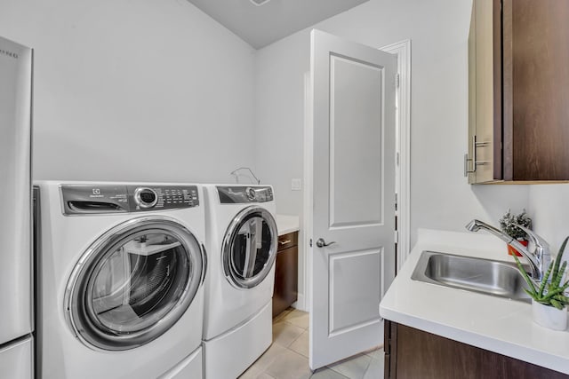 212 Saint Tropez Dr, Southlake, TX 76092 - laundry room featuring separate washer and dryer, cabinet space, and light tile patterned floors