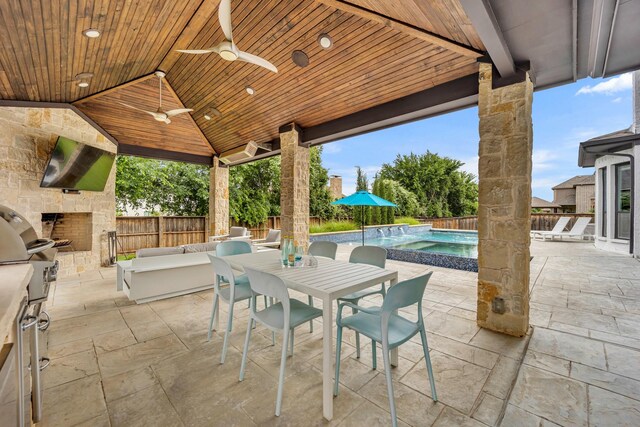 212 Saint Tropez Dr, Southlake, TX 76092 - view of patio / terrace with ceiling fan, a fenced backyard, a pool with connected hot tub, outdoor dining space, and an outdoor living space with a fireplace